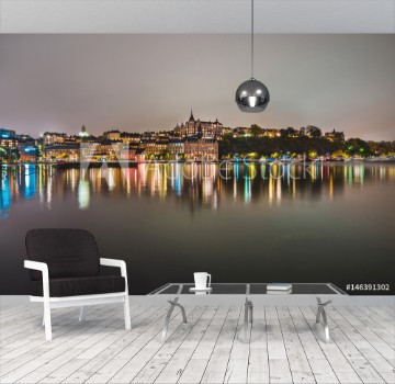 Picture of Stockholm city lights and night view of Sodermalm district buildings reflected in the water Evening Stockholm cityscape with illumination Riddarfjarden marina and Soder Malarstrand embankment